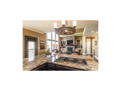 View of Stacked Stone Fireplace from Kitchen into 