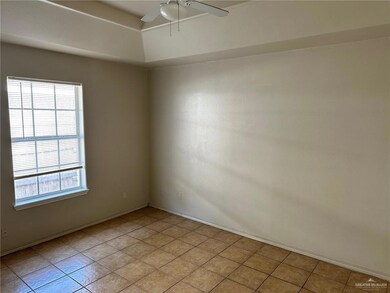 Spare room featuring ceiling fan and light tile patterned flooring