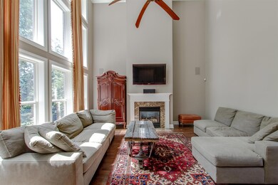 Another view of the Family Room showing the fireplace with gas logs, mantle with marble surround.  The entire main level has recent wide plank sand and finish hardwood floors.
