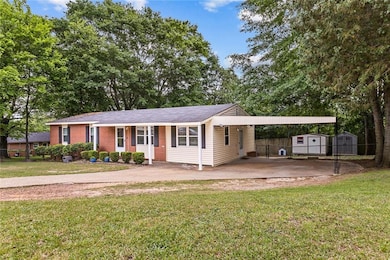 Ranch-style house with a front lawn, an outdoor st