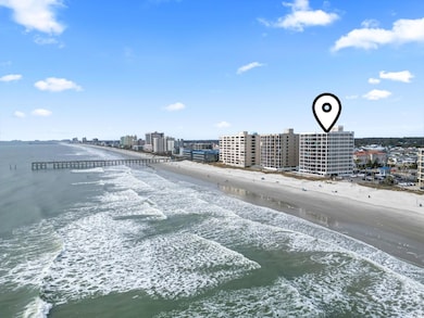Drone / aerial view with a water view and a beach 