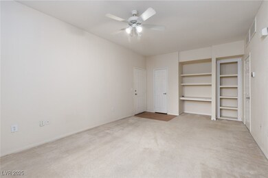 Living Room with book shelves, ceiling fan