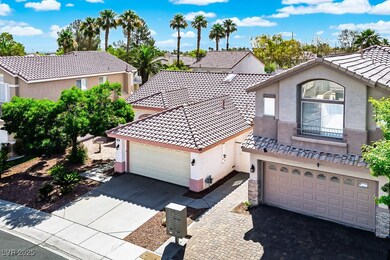 Mediterranean / spanish-style home with stucco siding, a garage, driveway, and a tile roof