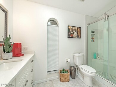 Bathroom with tile patterned floors, vanity, a sho