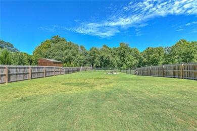 Backyard fully fence. Swingset does not convey. Tether ball pole and firepit do convey.