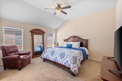Bedroom with baseboards, lofted ceiling, ceiling f