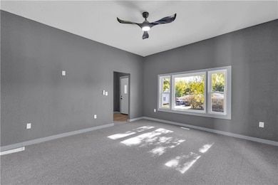 Open concept Living room with carpet flooring and a ceiling fan