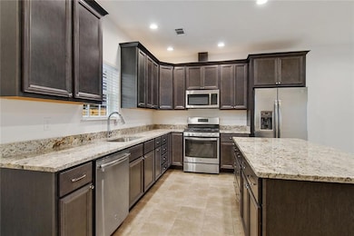 KITCHEN WITH GE APPLIANCES INCLUDING 5 BURNER GAS 