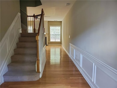 Stairway featuring wood finished floors