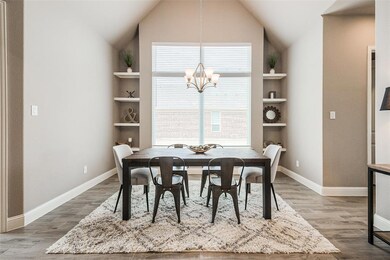 The dining area has a vaulted ceiling, large windo