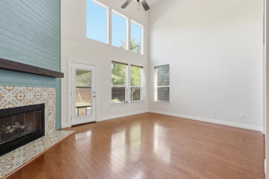 Family room featuring towering ceiling and windows overlooking backyard