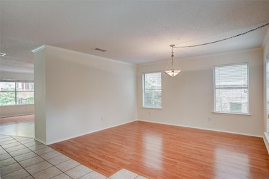 Unfurnished room featuring a textured ceiling, pl