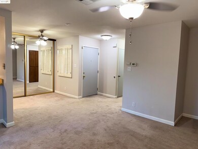 Dining room featuring a ceiling fan and light colored carpet