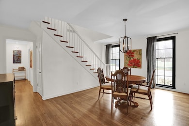 Dining room with a notable chandelier and wood-typ