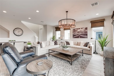 Living area featuring recessed lighting, a chandel