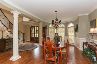 Elegant Dining Room with hardwood floors looks thr