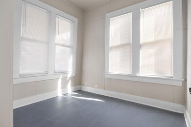 Unfurnished room with wood finished floors and ba