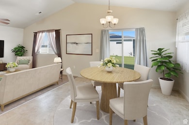 Dining space with a chandelier, vaulted ceiling, and light tile patterned floors