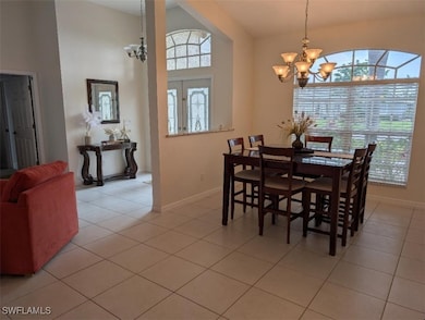 Dining room featuring a chandelier, baseboards, an