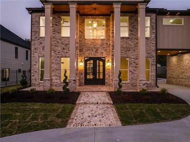 View of front of property with french doors, brick siding, and a porch