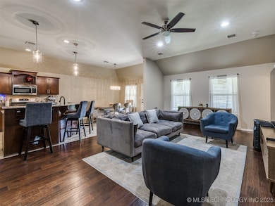 Living area featuring vaulted ceiling, recessed li