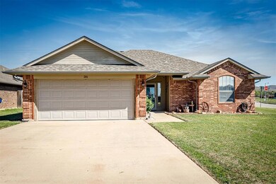 Ranch-style house with a garage and a front yard