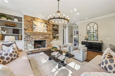 Gracious main living room with stacked stone fireplace and built-in bookcases