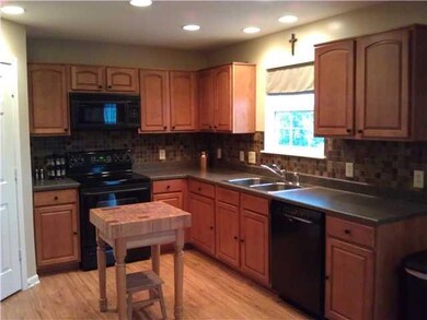 Kitchen. Large open kitchen with loads of cabinet space, walk-in pantry, new dishwasher and microwave, custom backsplash, loads of overhead lighting perfect for entertaining.  Water filtration system in fridge.  Laminate flooring complete this gorgeo