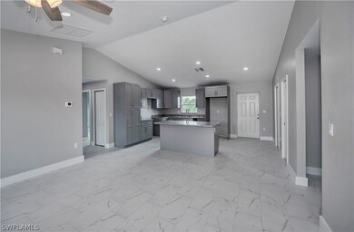 Kitchen featuring a center island, light tile floo