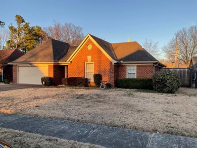 View of front facade featuring a garage, roof with