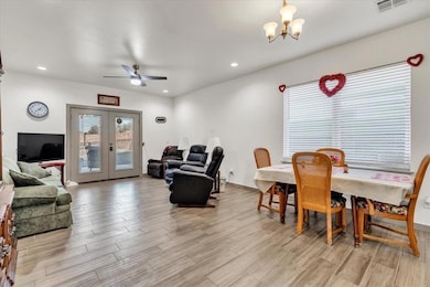 Dining space featuring french doors and ceiling fa