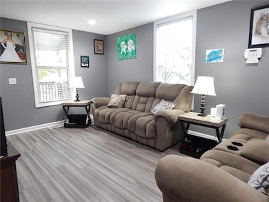 Living area featuring light wood-style floors and recessed lighting