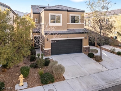 View of front facade featuring driveway, stone sid