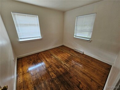 Spare room with dark hardwood / wood-style flooring
