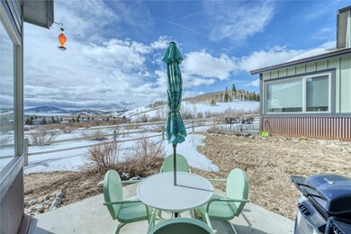 Snow covered patio with a grill, a mountain view,