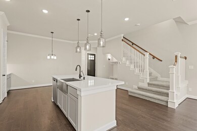Stylish island kitchen with light grey cabinets an