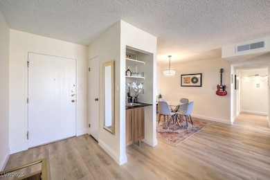 Entrance foyer featuring baseboards, visible vents