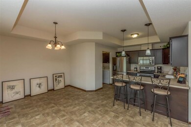 Kitchen and formal dining room area with trayed ce