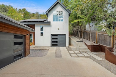 Rear view of property with stucco siding, solar p