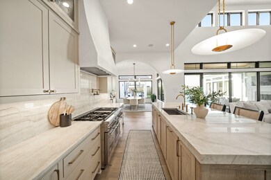 This kitchen boasts Thermador appliances including double dishwasher, 6 burner gas range with griddle, panel ready ice maker, double drawer beverage center, and beautiful range hood with undermount cabinet lighting and outlets with high end knobs and pulls on the soft close dovetail cabinetry.