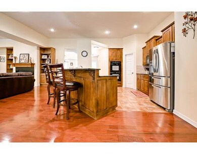 Kitchen. Large breakfast area, more stool area on other side, with granite countertops.