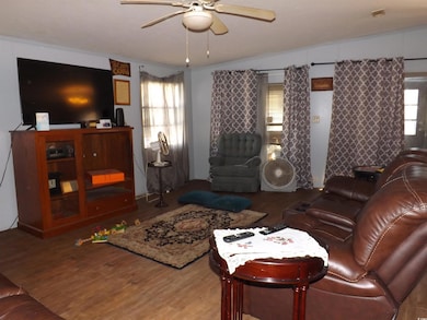 Living room with ceiling fan, ornamental molding, 