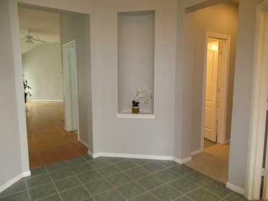 beautiful art niche in the foyer - hallway on the right leads to family bath and secondary bedrooms