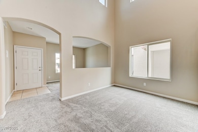 Entryway featuring carpet flooring, a towering cei