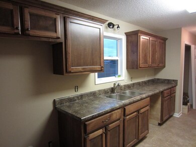 GALLEY STYLE KITCHEN WITH TILE FLOORS AND A FOUR F