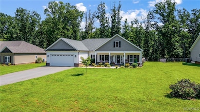 View of front facade with a garage, covered porch,
