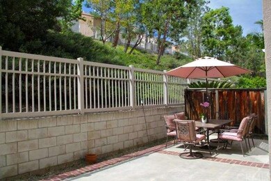 Backyard patio with a green slope view.  