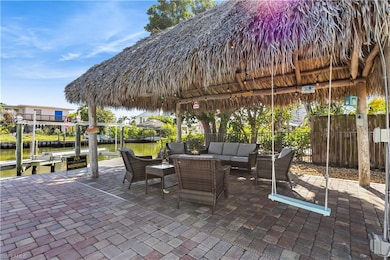 View of patio / terrace with an outdoor living space, a water view, a boat dock, boat lift, and a gazebo