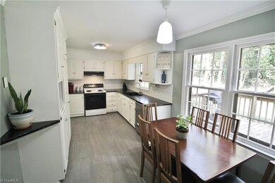 Renovated kitchen with high arc faucet, beautiful flooring, new dishwasher, granite countertops & new tile backsplash