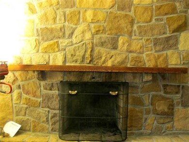 Family Room. One of two stone fireplaces, this one